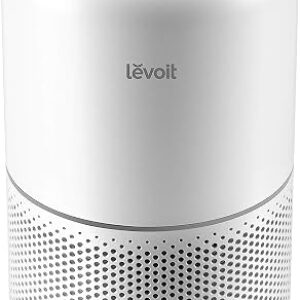 LEVOIT Core 300 air purifier in white standing beside a bed in a quiet bedroom