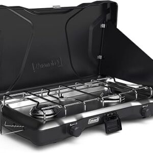 Coleman Triton camping stove, two-burner propane model in green with folding wind guards open